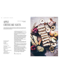 A page from "Queen of the Cakes – Gluten-Free Baking and Artistry" by Cozy Publishing shows an apple cheesecake slice recipe with a photo of the cake, dried apple rings, fresh apples, and decorating tips for an elegant touch.