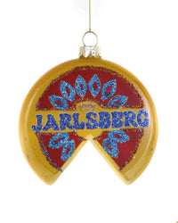 The Cody Foster Jarlsberg Ornament is a round glass decoration shaped like a wedge of Jarlsberg cheese, featuring red and yellow hues, blue glitter accents, and "JARLSBERG" in blue glitter—perfect for adding charm to your holiday décor.