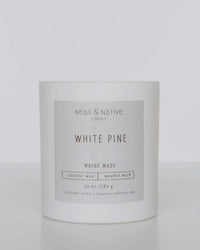 The Near & Native Coconut Wax Wood Wick Candle in White Pine features coconut soy wax, essential oils, a wooden wick, is Maine Made, and comes in a 10 oz minimalist container for a clean, natural burn.