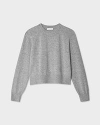 The White + Warren Cashmere Easy Sweatshirt in Grey Heather is a cropped crewneck with long sleeves and a classic shape, shown on a flat, light gray background.