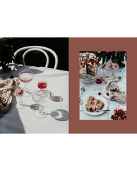 A table set outdoors with crystal glasses of pink drinks and a berry cake offers perfect inspiration for breakfast ideas from "Wonderful Morning – Recipes For A Delicious Start To the Day" by Cozy Publishing.