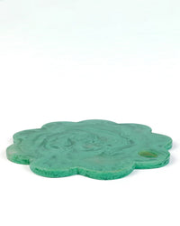 The Casa Amarosa 9in Scallop Resin Cheese/Charcuterie Board in Green features a marbled, flower-shaped design with a small round indentation, perfect for stylish serving. Shown against a white background.