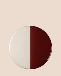 The Nuna Glazed 7.9 inch Tray by Bergs Potter features a ceramic design split between sandstone and deep burgundy, perfect for serving, and pairs beautifully with Nuna coasters for an elegant table setting.