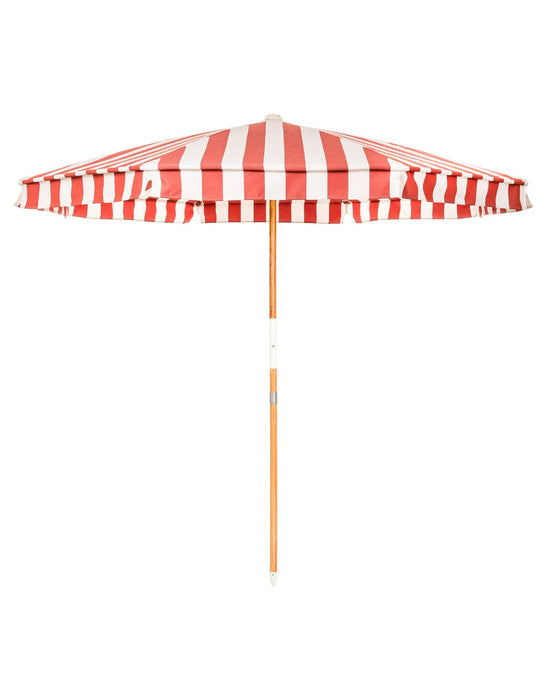 The Amalfi Umbrella - Crew Le Sirenuse Stripe by Business & Pleasure Co features a red and white stripe pattern, wooden pole, and UV resistant canopy, shown against a white background.