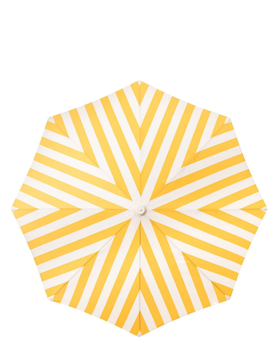 A top view of the Business & Pleasure Co Amalfi Umbrella - Crew Mimosa Yellow Stripe shows its UV-resistant, yellow and white striped canopy with a geometric pattern of alternating stripes radiating from the center.