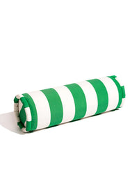 The Crew Canyon Green Stripe Bolster Pillow by Business & Pleasure Co features green and white stripes, is spill, stain, and fade resistant for indoor or outdoor use, and is shown on a plain white background.