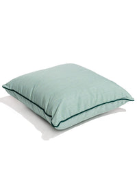 The Small Square Throw Pillow - Rivie Green by Business & Pleasure Co is a light green, subtly textured pillow made from durable Pleasuretex fabric with UV protection—ideal for indoor or outdoor use. Shown here on a white background with a soft shadow.