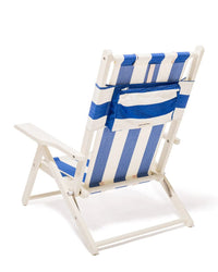 The Tommy Chair - Acacia White - Crew Mediterranean Blue Stripe by Business & Pleasure Co is a white outdoor canvas sling chair with blue and white stripes, shown from the back, featuring a sturdy frame and a zippered pocket on the backrest.