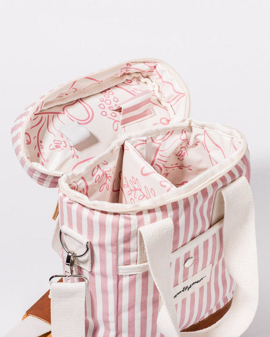 The Wine Cooler Tote Bag - Laurens Pink Stripe by Business & Pleasure Co features pink and white stripes, cream handles, a patterned interior with compartments, and insulation to keep items cool.