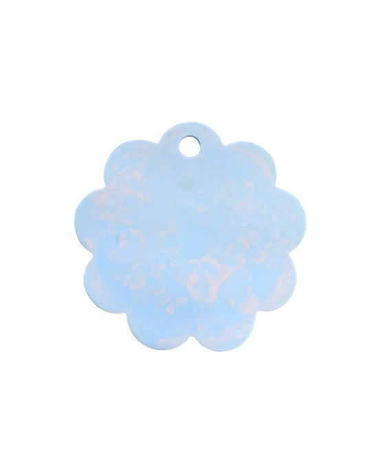 A light blue, flower-shaped tag with a small hole at the top adds charm to the Casa Amarosa 9in Scallop Resin Cheese/Charcuterie Board in Blue—ideal for accenting your next gathering.