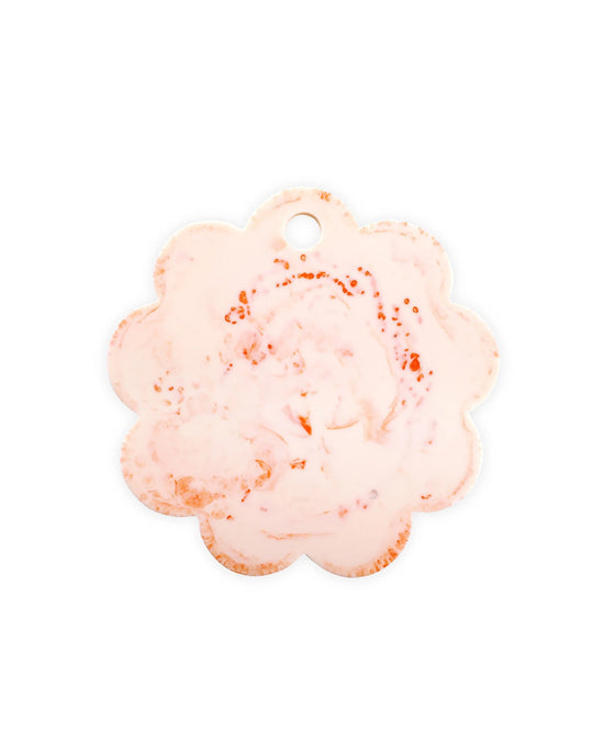A scalloped flower-shaped ceramic tag with a small hole at the top features a marbled pink and orange pattern—perfect for pairing with the Casa Amarosa 9in Scallop Resin Cheese/Charcuterie Board in Ivory Pink.
