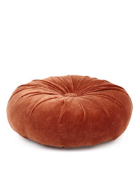 The Casa Amarosa Mini Velvet Round Pillow in Rust features a central tuft and petaled pleat design, making it a stylish decorative accent on any white background.