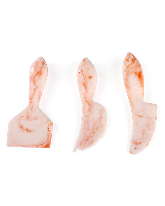 The Casa Amarosa Resin Cheese Knife Set of 3 in Ivory Pink features handmade, marbled knives with unique blade shapes—perfect for charcuterie boards and adding elegance to any entertaining spread.