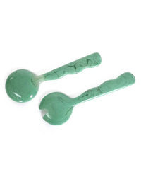 The Casa Amarosa Resin Salad Server Set in Green includes one solid spoon and one forked server, both with textured handles, handcrafted from marbled resin for a stylish addition to your table.