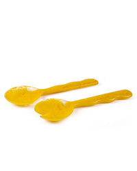 The Casa Amarosa Resin Salad Server Set in Mustard features a yellow spoon and spork, placed side by side on a white background.