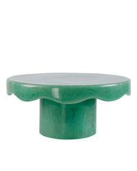 The Scallop Resin Cake Stand in Green by Casa Amarosa features a glossy, round wavy-edge top and cylindrical base.