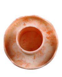 The Scallop Resin Cake Stand in Ivory Pink by Casa Amarosa is a round, shallow handmade stand with an elevated central cylindrical compartment, crafted from marbled orange and white resin and shown from above.
