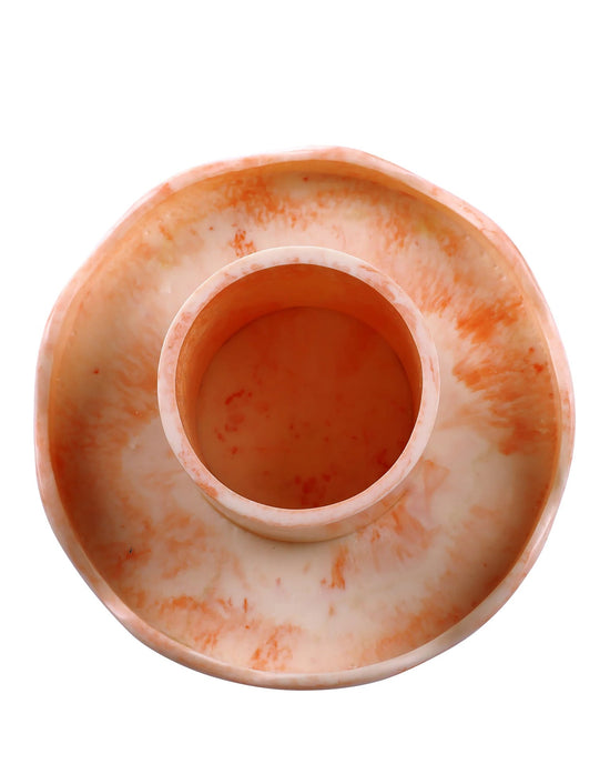 The Scallop Resin Cake Stand in Ivory Pink by Casa Amarosa is a round, shallow handmade stand with an elevated central cylindrical compartment, crafted from marbled orange and white resin and shown from above.