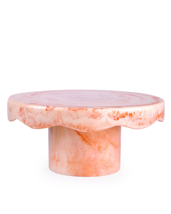 The Scallop Resin Cake Stand in Ivory Pink by Casa Amarosa features a round, wavy-edged top and cylindrical base, making it perfect for displaying your favorite treats.