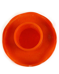 The Scallop Resin Cake Stand in Orange by Casa Amarosa features a circular design with a raised center ring—ideal for showcasing your favorite treats.