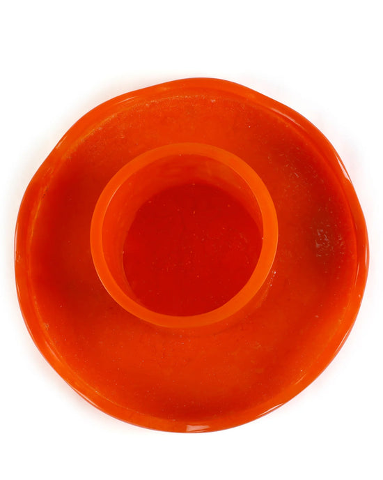 The Scallop Resin Cake Stand in Orange by Casa Amarosa features a circular design with a raised center ring—ideal for showcasing your favorite treats.