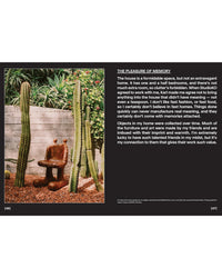 A wooden chair sits outdoors by tall cacti and lush plants, radiating natural wellness. Beside the image is text about memory and decor, inspired by Flamingo Estate: The Guide to Becoming Alive from Chronicle Books.