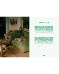 A man sits on a green couch next to a white dog in a warmly lit room, reflecting the nature-inspired vibe of Flamingo Estate: The Guide to Becoming Alive by Chronicle Books. The facing page shows the books introduction in green font.