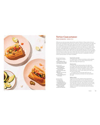 An open Mamacita cookbook by Chronicle Books displays a Tortas Guacamayas recipe on the right, inspired by family traditions, with two torta sandwiches on pink plates and limes on the left.