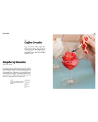 A hand holds a spoonful of bright red raspberry granita above a glass dish, next to a page from Recipes from Sicily by Chronicle Books featuring Coffee Granita and Raspberry Granita recipes.