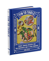 Tin to Table by Chronicle Books is a blue tinned seafood cookbook featuring illustrated dishes and the subtitle Fancy, Snacky Recipes for Tin-thusiasts and A-Fish-ionados on the cover.