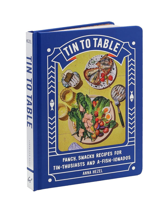 Tin to Table by Chronicle Books is a blue tinned seafood cookbook featuring illustrated dishes and the subtitle Fancy, Snacky Recipes for Tin-thusiasts and A-Fish-ionados on the cover.