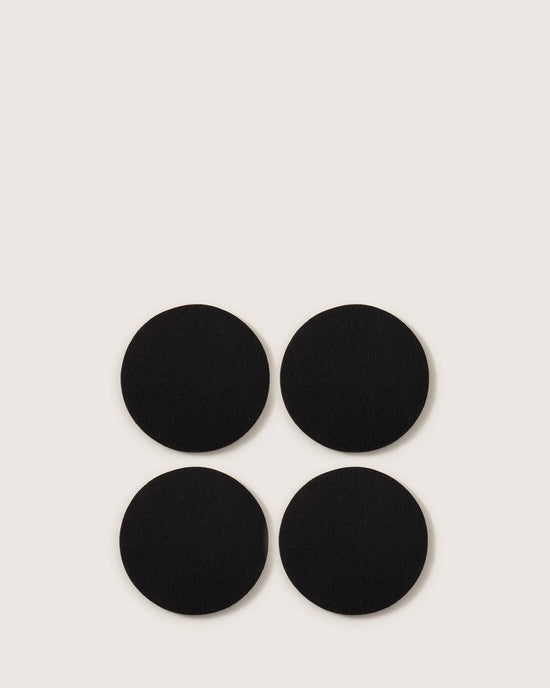 Four black Bierfilzl Merino Wool Felt Round Coasters by graf lantz, crafted from premium German merino wool, come in a set of 4—ideal for sustainable and stylish home décor.