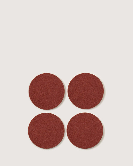The graf lantz Bierfilzl Merino Wool Round Coaster Solid in Terracotta (4 Pack) features four elegant, sustainably crafted coasters—perfect for adding style and function to your home décor.