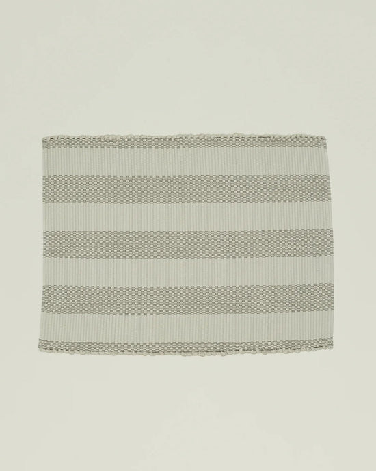 The Hawkins New York Essential Floor Mat in Light Grey features alternating horizontal light and medium gray stripes with a textured surface and finished edges—perfect as inspiration for a hand-loomed or recycled fiber rug.