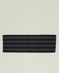 The Hawkins New York Essential Floor Runner in Black features horizontal dark gray stripes on black fabric—perfect as a hallway runner or a stylish, machine washable floor runner for modern spaces.