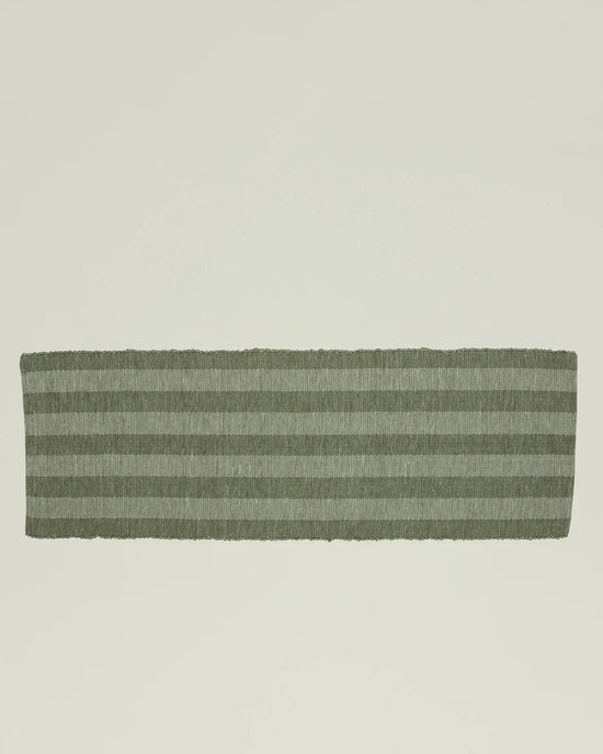 The Hawkins New York Essential Floor Runner in Olive, a rectangular hand-loomed rug with horizontal light and dark green stripes made from recycled fibers, is displayed on a plain light background.