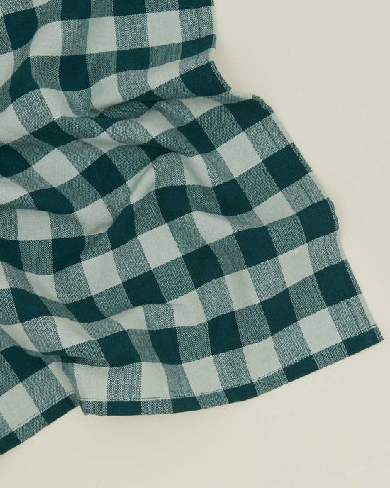 A set of Hawkins New York Essential Gingham Dinner Napkins in Sky/Peacock, featuring a green and white checkered pattern, is displayed flat against a light background.