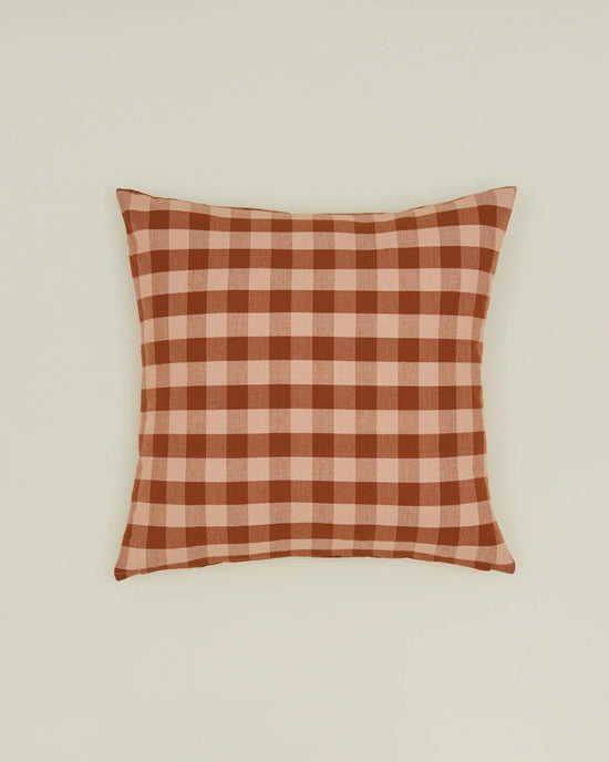 The Hawkins New York Essential Gingham Pillow, 18x18 inches in Blush/Terracotta European linen, features a red and beige check pattern and comes with a down insert for added comfort. Displayed against a plain light background.
