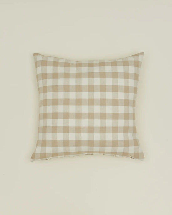 The Hawkins New York Essential Gingham Pillow, 18x18 inches in Ivory/Flax, features a beige and white check pattern in European linen. Machine washable, it combines timeless style and easy care for any space.