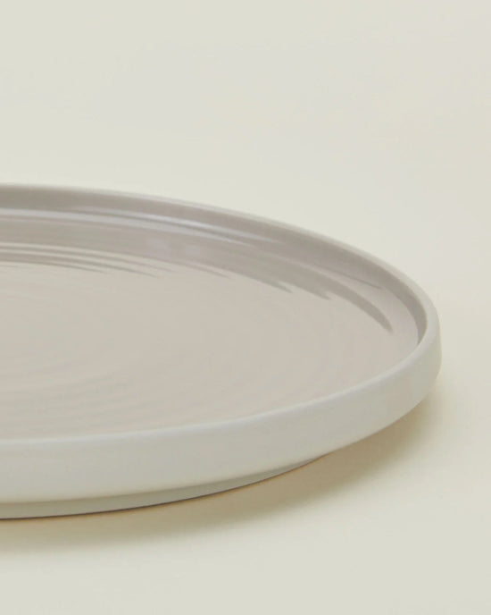 A close-up of Hawkins New Yorks Essential Salad Plates in Light Grey—a set of 4 stoneware plates—shown on a neutral background.