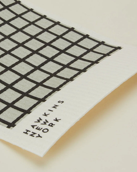 A set of 6 rectangular, eco-friendly Swedish dishcloths in light grey/black from Hawkins New York, each featuring a black grid pattern and branded text on one edge.