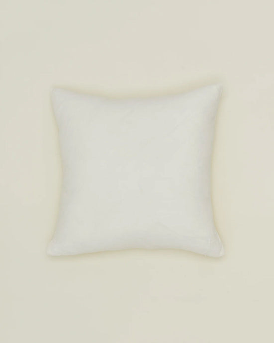 The Simple Linen Pillow - 18 X 18 Inches in Ivory by Hawkins New York, featuring a down insert, is centered against a light beige background.