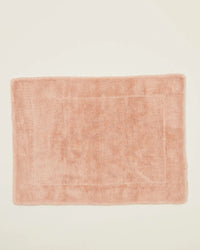 The Hawkins New York Simple Terry Bath Mat in Blush is rectangular with a plush texture and subtle border, shown on a plain off-white background.