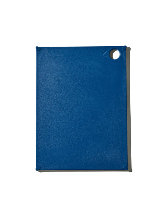 The (grippy) reBoard® | Lapis by Material is a rectangular blue BPA-free cutting board with a textured surface and a circular hole at the top right, shown on a plain white background.