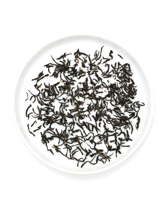 Onyx Coffee Lab’s Earl Grey Tea sachets are arranged on a round white plate.