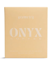 A beige 10oz bag of Onyx Coffee Lab Geometry features minimalist white text, labeled as light roast whole bean coffee for espresso or filter brewing.