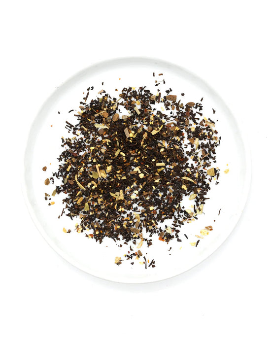 Loose leaf Gochujang Chai Tea by Onyx Coffee Lab, featuring a blend of mixed spices and herbs, displayed on a white plate and photographed from above against a white background. Includes 15 sachets.