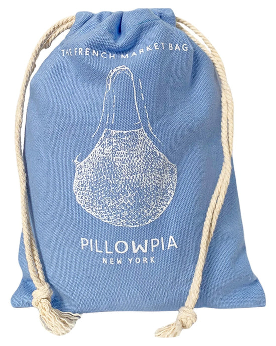 The French Market Bag No.2 in French Blue by PILLOWPIA is an organic cotton bag with white drawstring ropes, printed text The French Market Bag, PILLOWPIA New York, and a vintage net bag line drawing on the front.