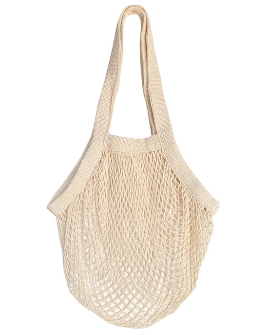 The French Market Bag No.2 In Natural by PILLOWPIA is a beige organic cotton mesh shopping bag with two handles, shown against a white background.