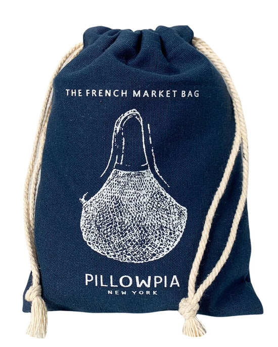 The French Market Bag No.2 in Navy by PILLOWPIA features white rope handles, printed branding, and a charming illustration—an organic cotton bag for stylish, sustainable carrying.